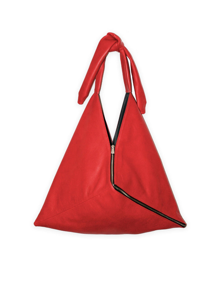 Red slouchy hobo bag with black trim, top zipper, and two rolled handles.