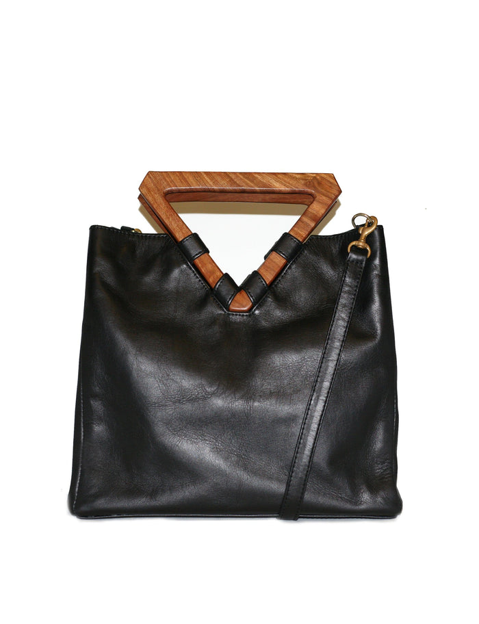 Perfect bag for business and pleasure. Made from leather with wooden geometric top handle. Also includes removable shoulder strap. 
