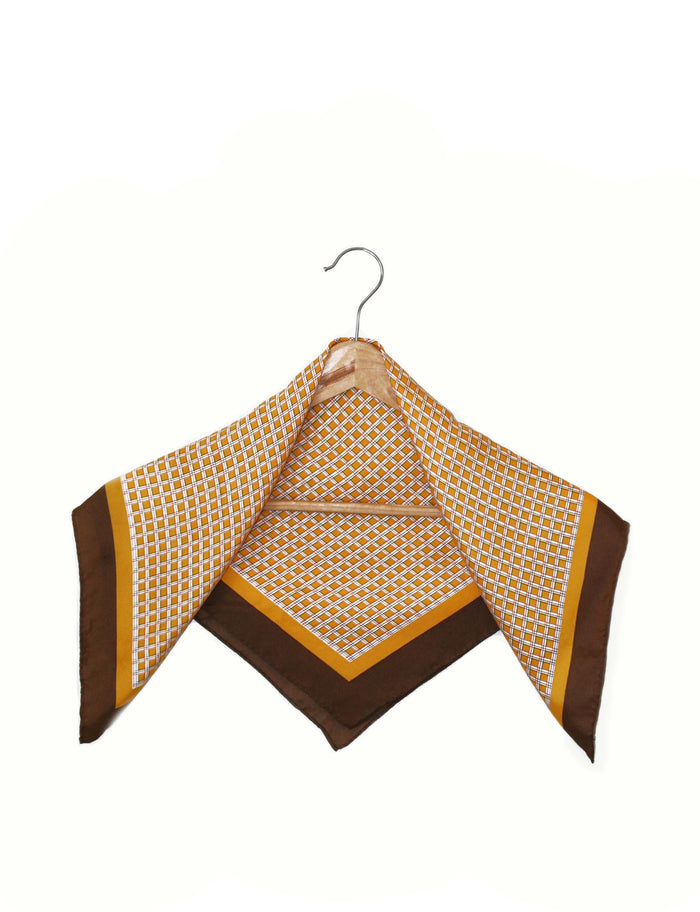 Square scarf on hanger, orange lattice pattern with dark brown corner accents