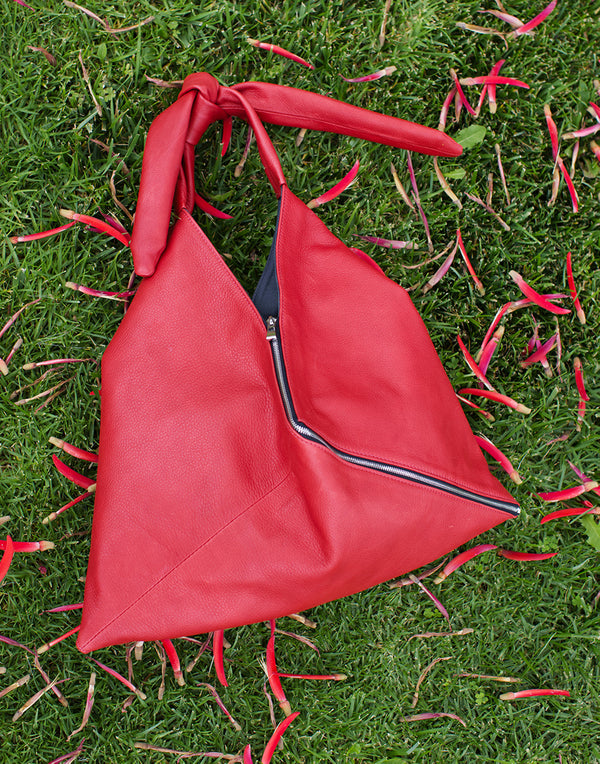 Red Remy Hobo bag outdoors
